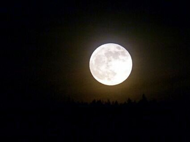 A supermoon delayed by clouds eventually shines on Seychelles