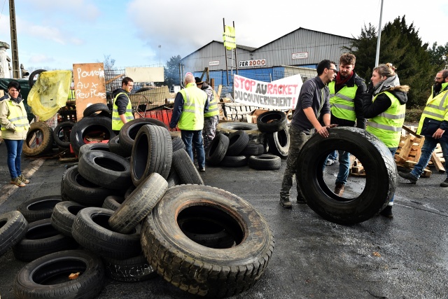 Macron retreats on fuel tax hikes in bid to calm French protests