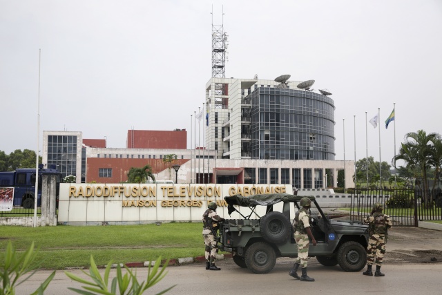 After months abroad, Gabon's Bongo swears in new government