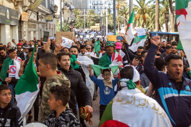 Tens of thousands protest in Algeria as Bouteflika stays defiant