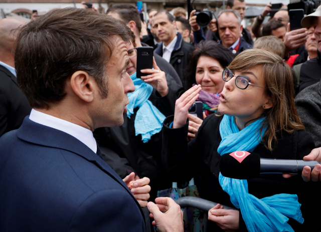 Macron booed by angry French after signing pensions reform